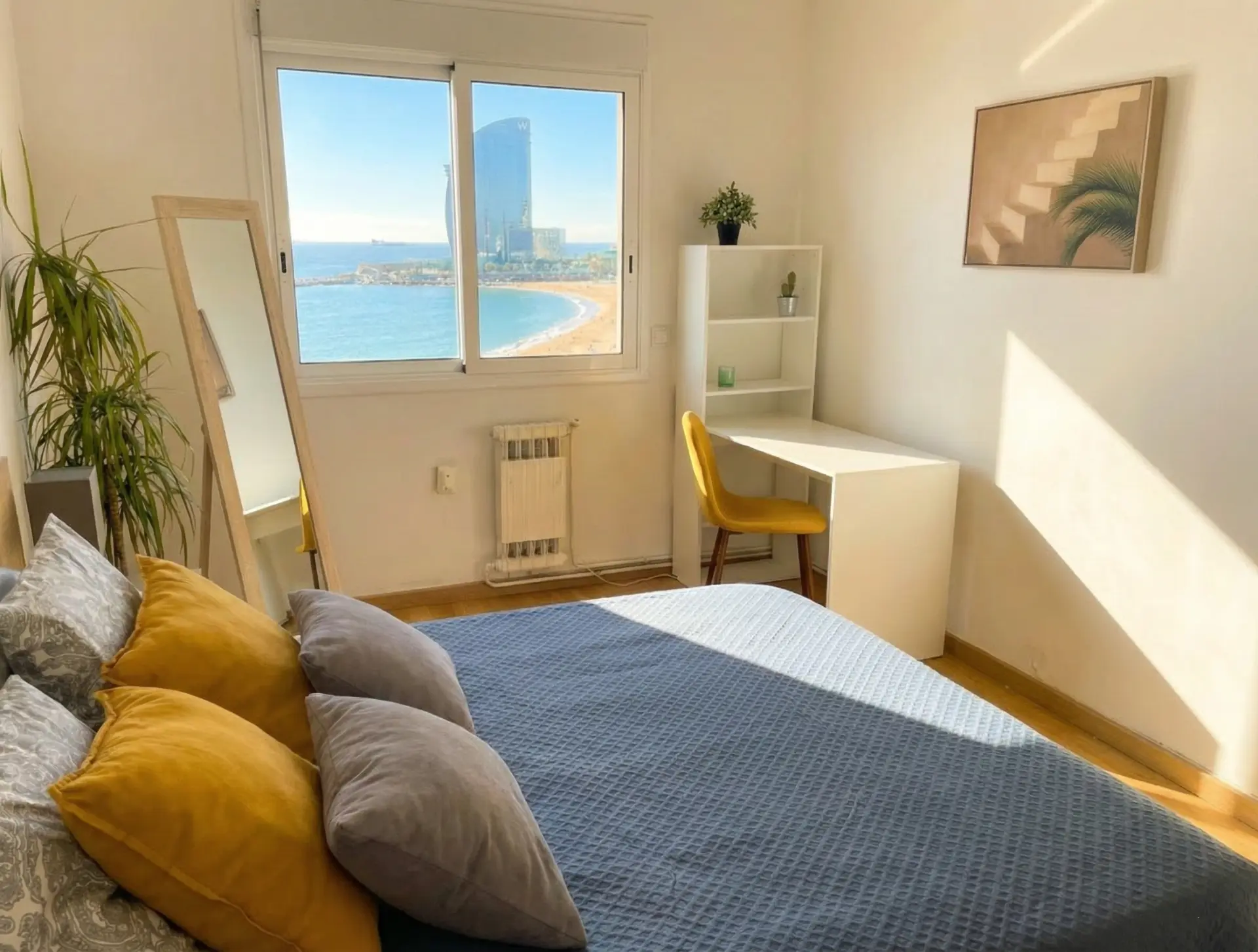 The sea-view bedroom with a desk at the window