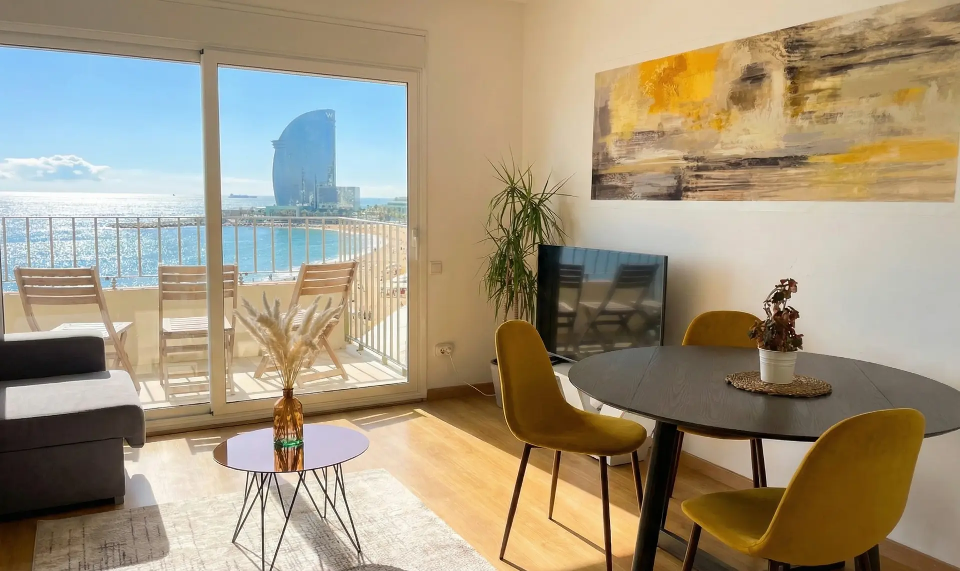 The living room and dining table, with the balcony and the sea beyond